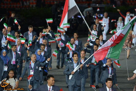 Iran's flagbearer Ali Mazaheri (C) leads his delegation during the opening ceremony of the London 2012 Olympic Games on July 27, 2012 at the Olympic Stadium in London.     AFP PHOTO / GABRIEL BOUYS        (Photo credit should read GABRIEL BOUYS/AFP/GettyImages)